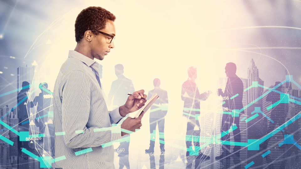 Man standing and writting on pad with other people behind him and graph chart lines overlayed ontop